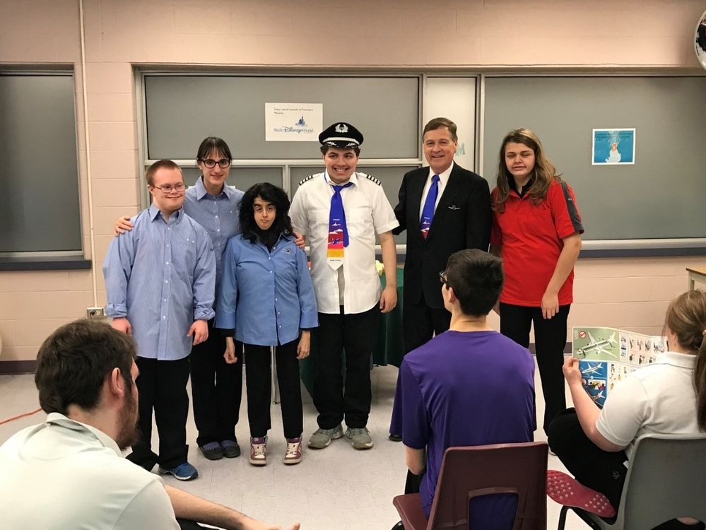 Craig pictured with students wearing Southwest Flight Attendant and Pilot uniforms