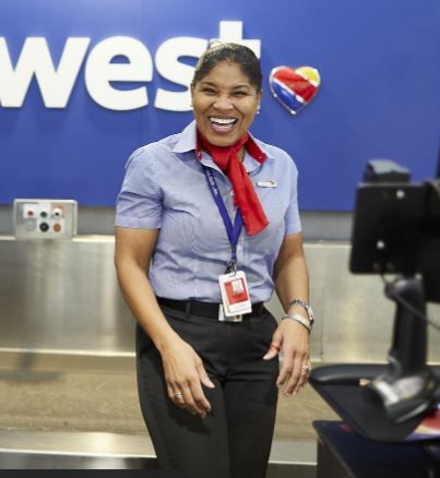 Houston Customer Service Agent Janice Maddux flashes a smile while dishing out Southwest's legendary Hospitality.