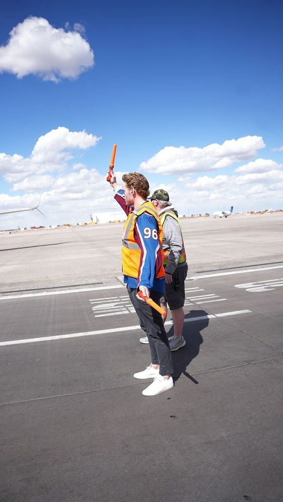 Colorado Avalanche hockey player, Mikko Rantanen and Southwest Ground Operations Employees marshaling an aircraft