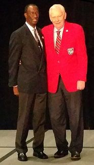 Brig. Gen. Leon Johnson, USAF (Ret.) and National Tuskegee Airmen, Inc. President adorns Herb with the traditional “Red Jacket” at the Tuskegee Airmen, Inc. 45th National Convention Youth Luncheon.